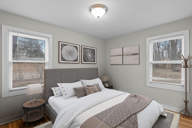 3401 Meadow Ln, Minnetonka, MN 55345 - bedroom with wood finished floors, multiple windows, and baseboards