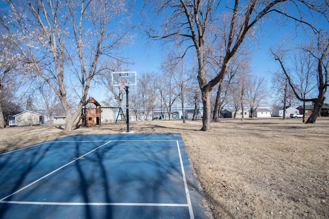 view of sport court with a playground and basketball hoop