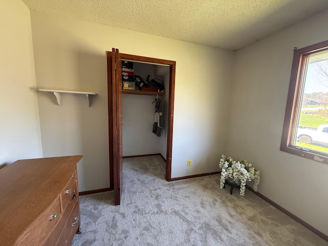 7996 Corey Path, Inver Grove Heights, MN 55076 - unfurnished bedroom with a textured ceiling, light colored carpet, a spacious closet, a closet, and baseboards
