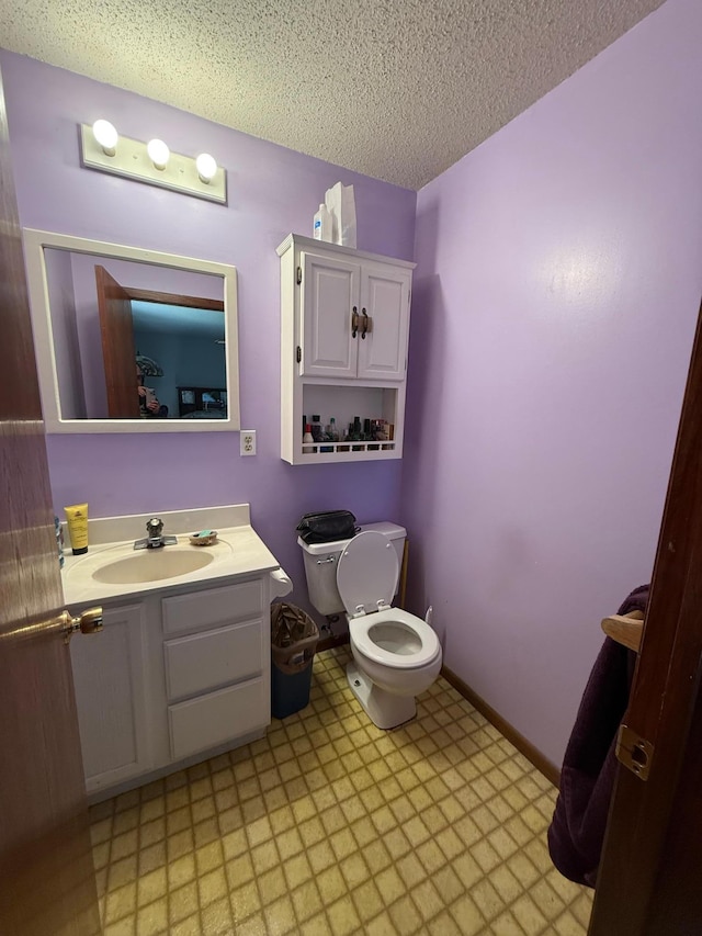 7996 Corey Path, Inver Grove Heights, MN 55076 - bathroom with tile patterned floors, toilet, a textured ceiling, and vanity
