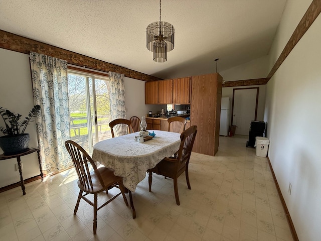 7996 Corey Path, Inver Grove Heights, MN 55076 - dining room with light floors, baseboards, a textured ceiling, and a chandelier