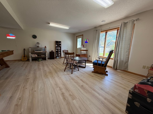 7996 Corey Path, Inver Grove Heights, MN 55076 - dining area with a textured ceiling, light wood finished floors, and baseboards