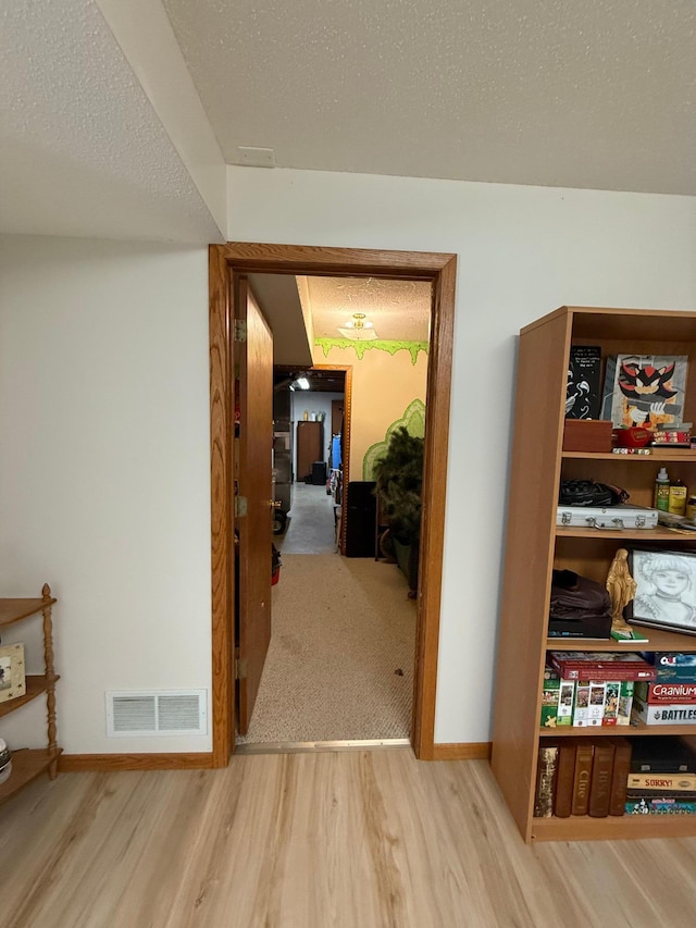 7996 Corey Path, Inver Grove Heights, MN 55076 - hall featuring wood finished floors, baseboards, and a textured ceiling