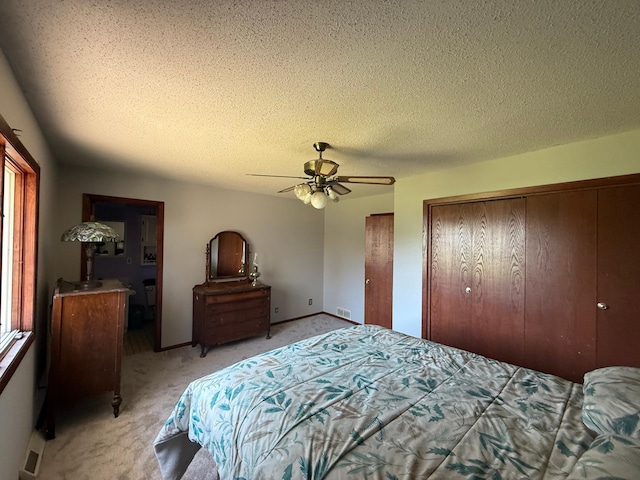7996 Corey Path, Inver Grove Heights, MN 55076 - bedroom featuring light carpet, a textured ceiling, a ceiling fan, multiple closets, and baseboards