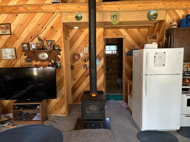 47241 186th Pl, Mcgregor, MN 55760 - carpeted living area with a wood stove and wood walls