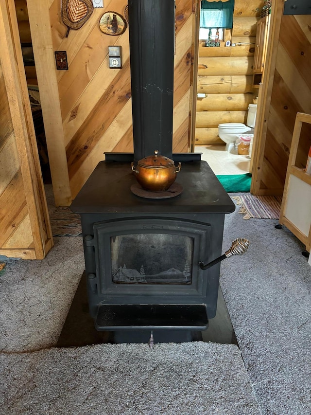 47241 186th Pl, Mcgregor, MN 55760 - detailed view of a wood stove, log walls, and carpet flooring