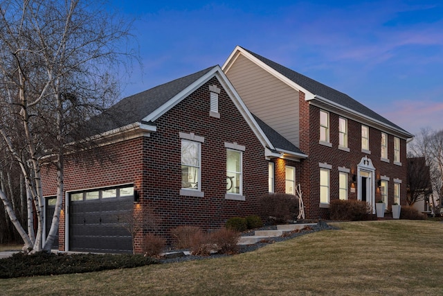 16500 Irwindale Way, Lakeville, MN 55044 - view of front of home featuring brick siding, a front yard, an attached garage, and roof with shingles