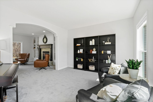 16500 Irwindale Way, Lakeville, MN 55044 - living area featuring carpet, arched walkways, a fireplace, and baseboards