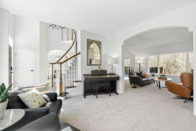 16500 Irwindale Way, Lakeville, MN 55044 - living area with arched walkways, carpet flooring, stairway, and baseboards