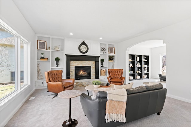 16500 Irwindale Way, Lakeville, MN 55044 - living area featuring baseboards, light carpet, a stone fireplace, plenty of natural light, and recessed lighting