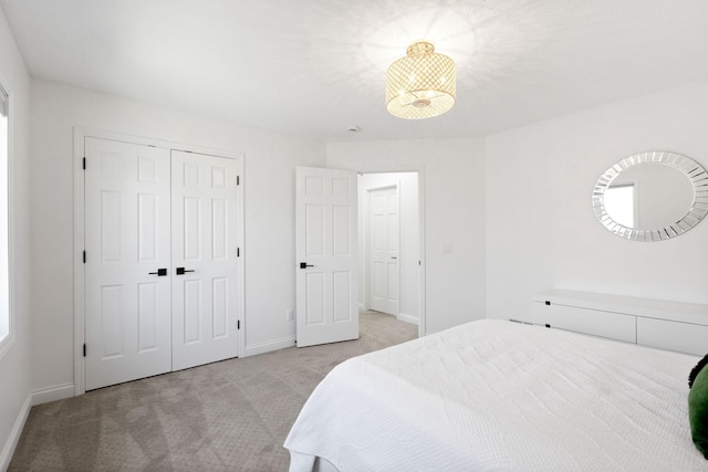 16500 Irwindale Way, Lakeville, MN 55044 - bedroom with light colored carpet, baseboards, a closet, and a chandelier