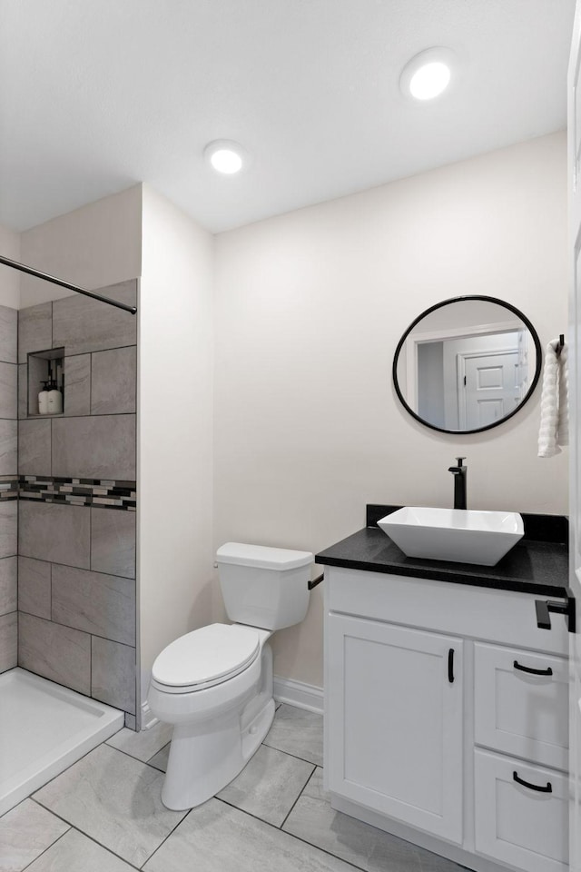 16500 Irwindale Way, Lakeville, MN 55044 - full bath featuring vanity, a tile shower, toilet, baseboards, and tile patterned floors