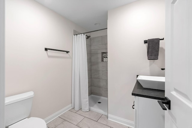 16500 Irwindale Way, Lakeville, MN 55044 - full bath featuring baseboards, toilet, tiled shower, tile patterned flooring, and vanity