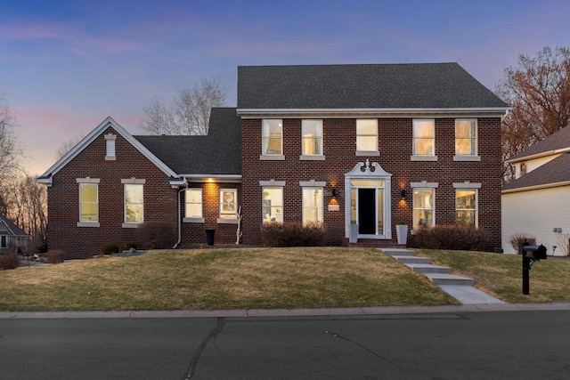 16500 Irwindale Way, Lakeville, MN 55044 - view of front of property with brick siding, a yard, and roof with shingles