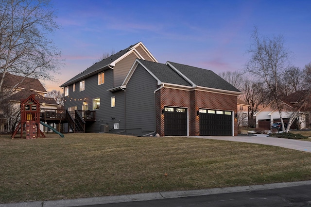 16500 Irwindale Way, Lakeville, MN 55044 - property exterior at dusk with driveway, a yard, an attached garage, cooling unit, and brick siding