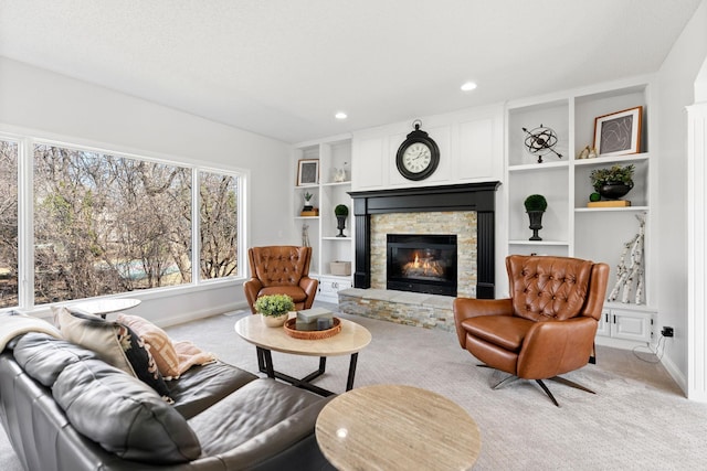 16500 Irwindale Way, Lakeville, MN 55044 - living room featuring light colored carpet, baseboards, a stone fireplace, recessed lighting, and built in shelves