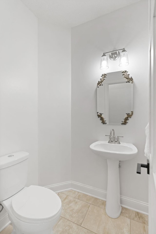 16500 Irwindale Way, Lakeville, MN 55044 - half bathroom featuring toilet, tile patterned flooring, and baseboards