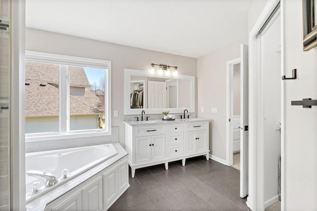 16500 Irwindale Way, Lakeville, MN 55044 - bathroom with double vanity, a bath, and baseboards