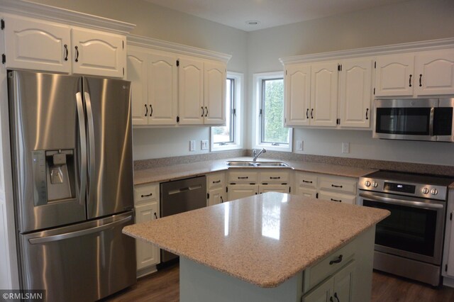 1706 Fairway Dr, Glencoe, MN 55336 - kitchen with stainless steel appliances, a sink, white cabinetry, a kitchen island, and dark wood-type flooring