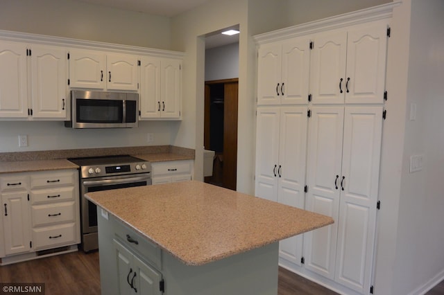 1706 Fairway Dr, Glencoe, MN 55336 - kitchen with stainless steel appliances, dark wood-style floors, white cabinets, and a center island