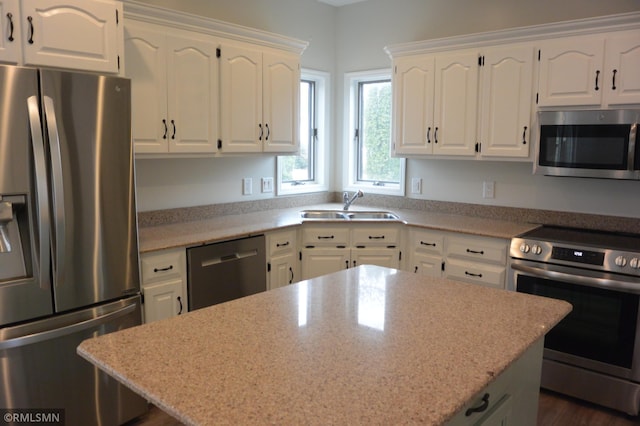 1706 Fairway Dr, Glencoe, MN 55336 - kitchen with stainless steel appliances, a sink, a kitchen island, white cabinets, and light stone countertops