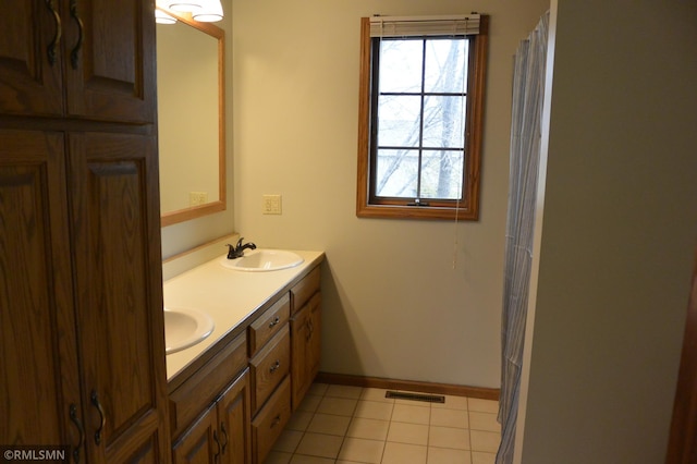 1706 Fairway Dr, Glencoe, MN 55336 - bathroom with double vanity, tile patterned flooring, baseboards, and curtained shower