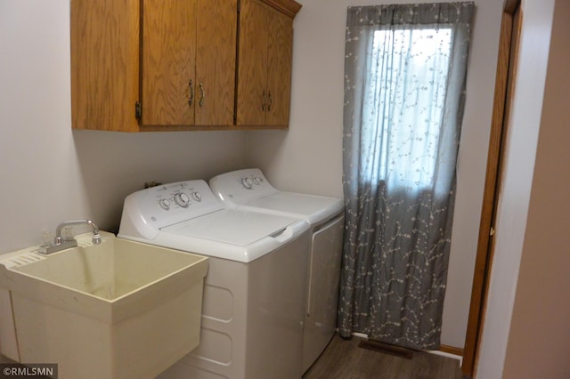 1706 Fairway Dr, Glencoe, MN 55336 - laundry room featuring washer and clothes dryer, cabinet space, and dark wood-style floors