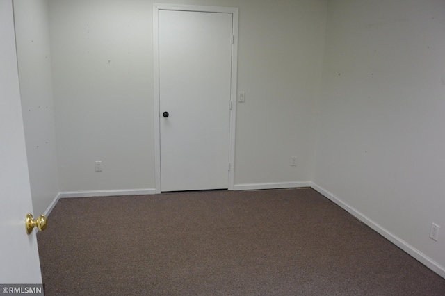 1706 Fairway Dr, Glencoe, MN 55336 - unfurnished bedroom featuring dark colored carpet and baseboards