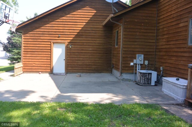 1706 Fairway Dr, Glencoe, MN 55336 - rear view of house with central AC and a patio