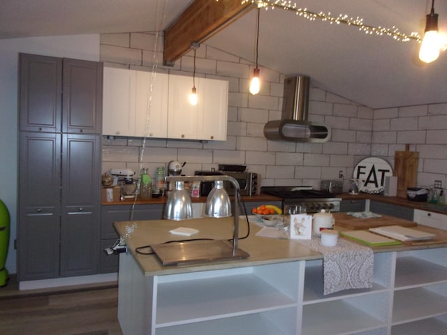 kitchen featuring ventilation hood, decorative backsplash, stove, and a kitchen island