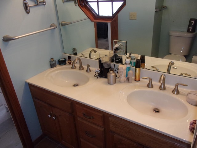 full bath with toilet and double vanity