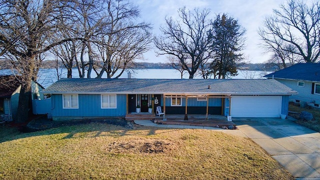 ranch-style home featuring concrete driveway, a garage, a front yard, a porch, and board and batten siding