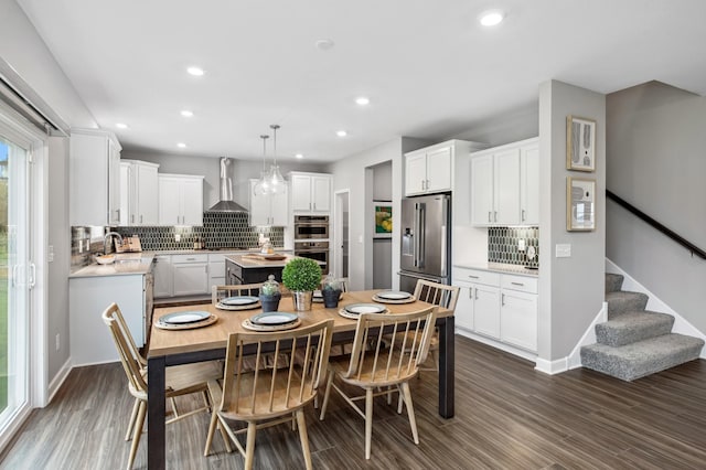 dining area with recessed lighting, baseboards, stairs, and dark wood-style floors