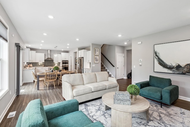 living room featuring recessed lighting, stairway, visible vents, a wealth of natural light, and baseboards
