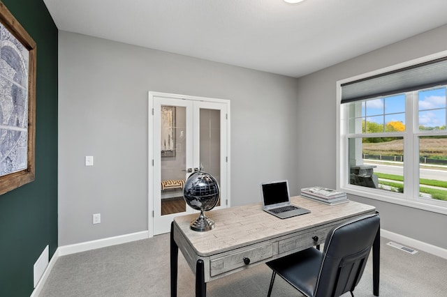 carpeted office featuring baseboards, french doors, visible vents, and a wealth of natural light
