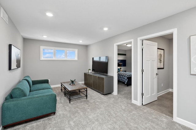 carpeted living area with baseboards, visible vents, and recessed lighting