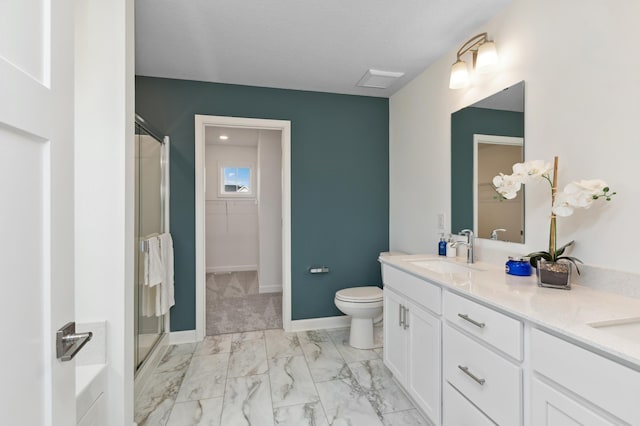 full bathroom featuring a sink, double vanity, toilet, a stall shower, and marble finish floor