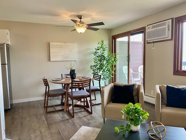 dining area with dark wood finished floors, a ceiling fan, baseboards, a wall unit AC, and a baseboard heating unit