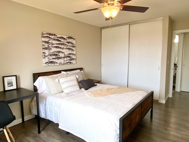 bedroom with a closet, a ceiling fan, baseboards, and wood finished floors