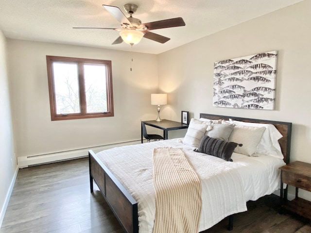 bedroom with baseboards, a baseboard radiator, a ceiling fan, and wood finished floors