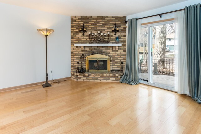 2749 Terraceview Ln N, Plymouth, MN 55447 - unfurnished living room with wood finished floors and a brick fireplace