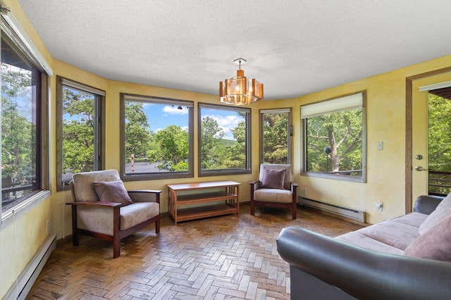 1109 Hamilton St, Saint Croix Falls, WI 54024 - sunroom / solarium with baseboard heating, a baseboard radiator, a chandelier, healthy amount of natural light, and a textured ceiling