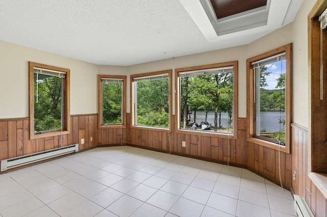1109 Hamilton St, Saint Croix Falls, WI 54024 - unfurnished sunroom with a baseboard heating unit, wainscoting, a water view, baseboard heating, and wooden walls
