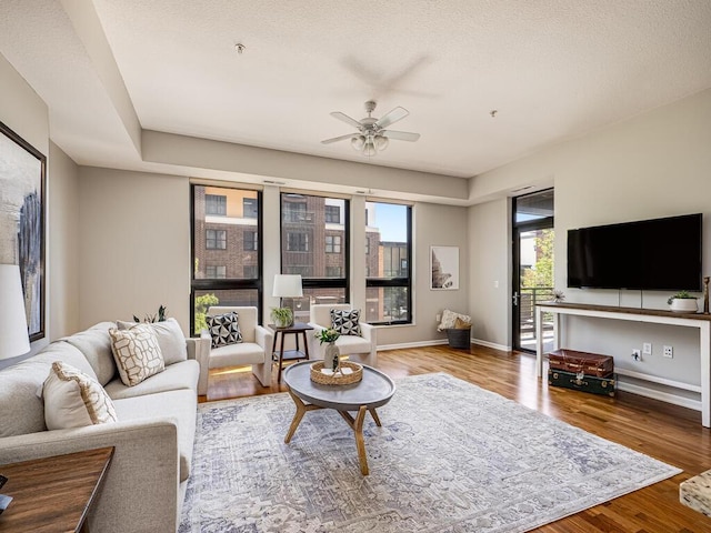 4730 Park Commons Dr Unit 215, Saint Louis Park, MN 55416 - living room featuring a ceiling fan, wood finished floors, and baseboards