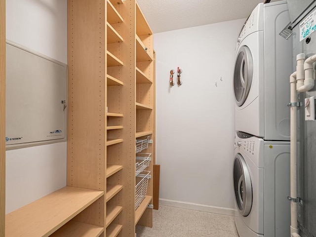 4730 Park Commons Dr Unit 215, Saint Louis Park, MN 55416 - laundry room with stacked washing machine and dryer and baseboards