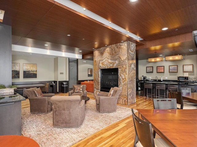 4730 Park Commons Dr Unit 215, Saint Louis Park, MN 55416 - living room featuring wood ceiling, wood finished floors, a glass covered fireplace, recessed lighting, and wet bar