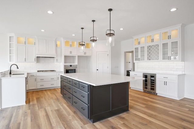 13937 Ember Ct, Apple Valley, MN 55124 - kitchen featuring wine cooler, stainless steel appliances, decorative backsplash, white cabinetry, and recessed lighting