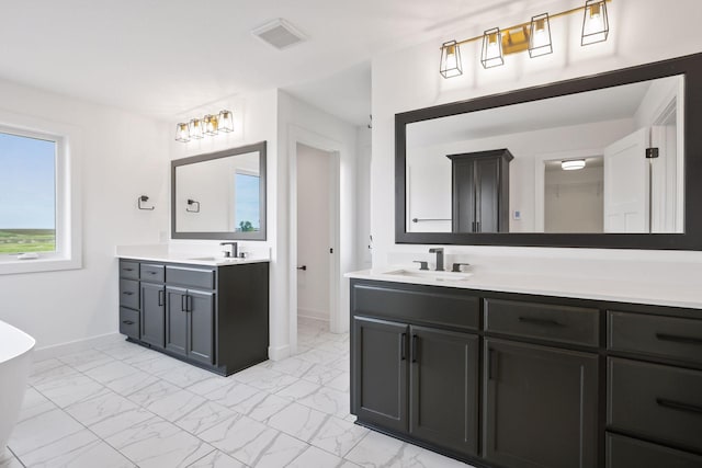 13937 Ember Ct, Apple Valley, MN 55124 - bathroom featuring marble finish floors, vanity, and a freestanding tub