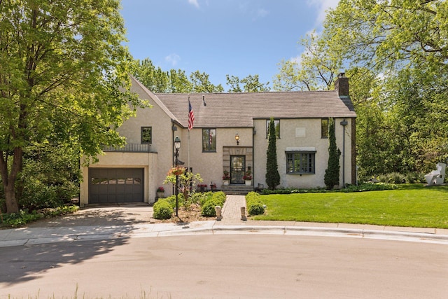 7 Montcalm Ct, Saint Paul, MN 55116 - view of front facade with a chimney, driveway, an attached garage, stucco siding, and a front lawn