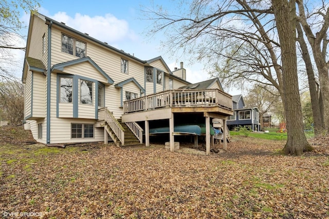 back of house featuring a wooden deck and stairway